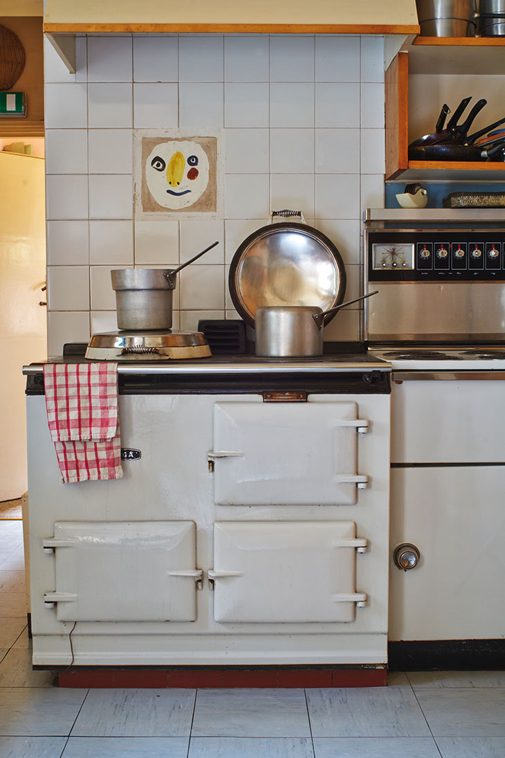 The kitchen at Farleys, East Sussex, with a tile by Picasso above the Aga.