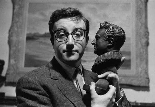 Peter Sellers holding a bust of himself.