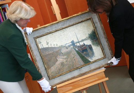 Monika Gruetters (left) hands over the painting ‘Quai de Clichy’ by Paul Signac to Agnes Sevestre-Barbe, representative of the heiress, as part of the return of art stolen under the Nazis and hoarded by Cornelius Gurlitt, the son of Nazi-era dealer Hildebrand Gurlitt in Berlin on July 3, 2019.