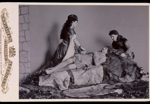 Photograph taken at Balmoral in 1893/94 by Charles Albert Wilson. Ethel Cadogan, Lord William Cecil and Dr Alexander Profeit re-enact a scene from Ivanhoe by Sir Walter Scott in which Rebecca and a page kneel over Ivanhoe. Royal Collection Trust/© HM Queen Elizabeth II 2020