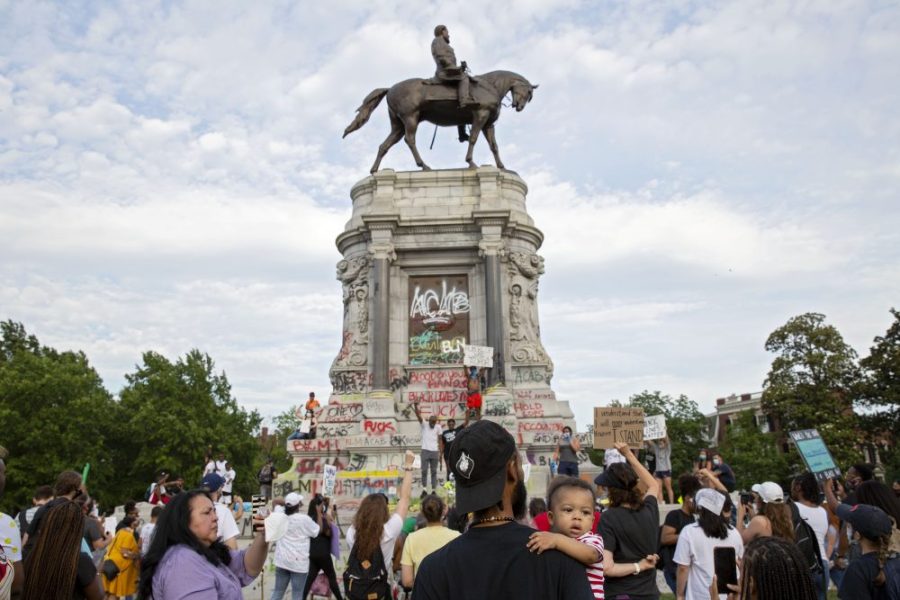 People gather around the Robert E. Lee statue on Monument Avenue in Richmond, Virginia, on June 4, 2020. Earlier, Virginia governor Ralph Northam announced plans to remove the statue of the Confederate general. Photo: Ryan M. Kelly/AFP via Getty Images