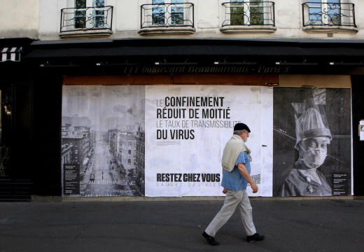 Pasted photographs by Gaia Squarci (Prospekt), and Ashely Gilbertson (VII) on Boulevard des Filles du Calvaire, Paris, 2020.