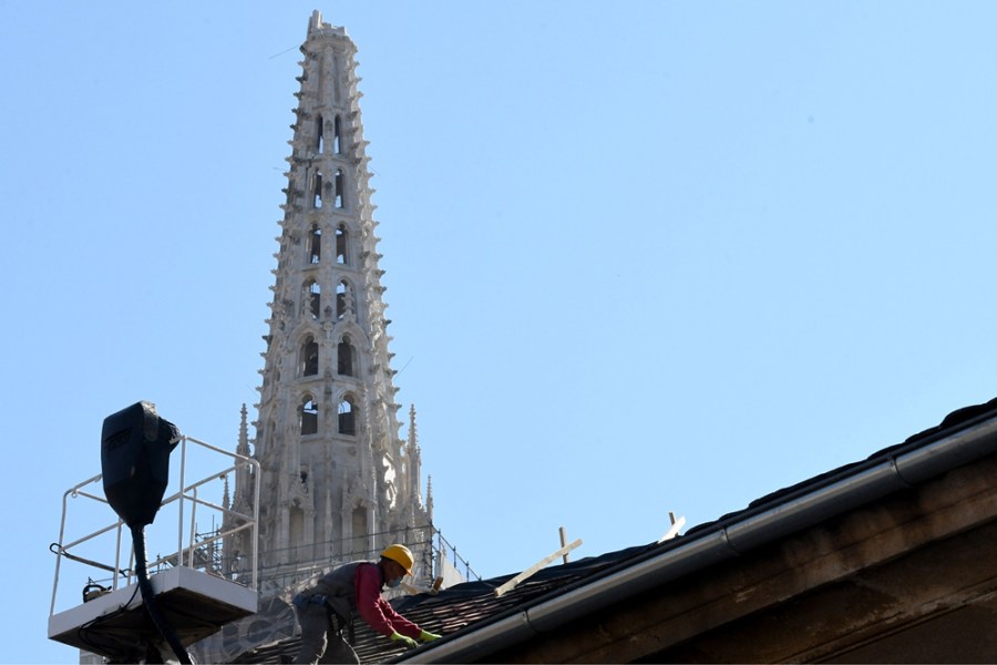 A builder works on the roof of the south tower of Zagreb's cathedral in April 2020 following the 5.3-magnitude earthquake in downtown Zagreb on 22 March. Photo: DENIS LOVROVIC/AFP via Getty Images