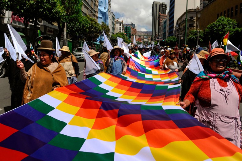 Demonstrators hold a Wiphala flag during a march called by students of the Universidad Mayor de San Andres and neighbourhood organisations march demanding peace in La Paz, on November 19, 2019. Photo by Jorge Bernal/AFP via Getty Images