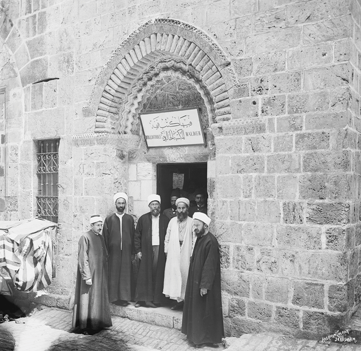 Members of the Khalidi family outside the newly opened library, (c. 1900), with (in white) Sheikh Taher al Jazaireh, founder of the Zahiriyya library in Damascus. 