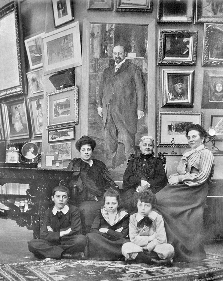 Margarita Morozov (far left) with her children and others in 1903, in front of the portrait of Mikhail Morozov by Valentin Serov (1902)