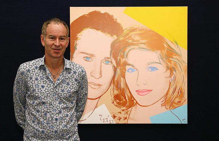 Double vision: John McEnroe standing in front of Andy Warhol’s 1986 portrait of McEnroe and Tatum O’Neil from 1986.