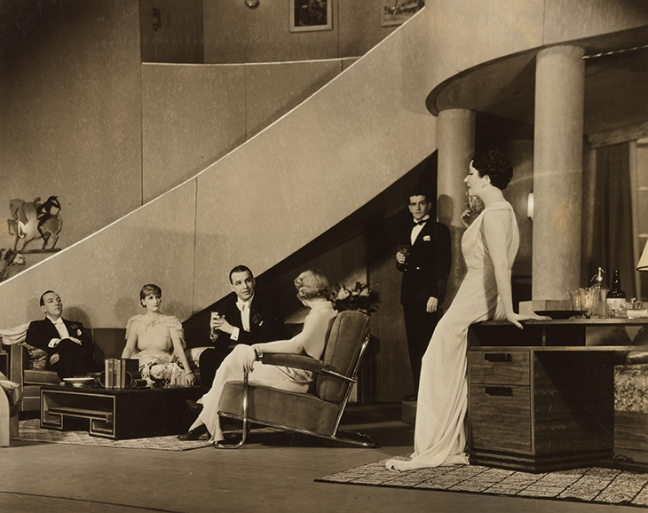 Noél Coward (far left), Ethel Borden, Alfred Lunt, Gladys Henson, Alan Campbell and Lynn Fontanne in the original Broadway production of Design for Living in 1953, with sets designed by Gladys Calthrop.