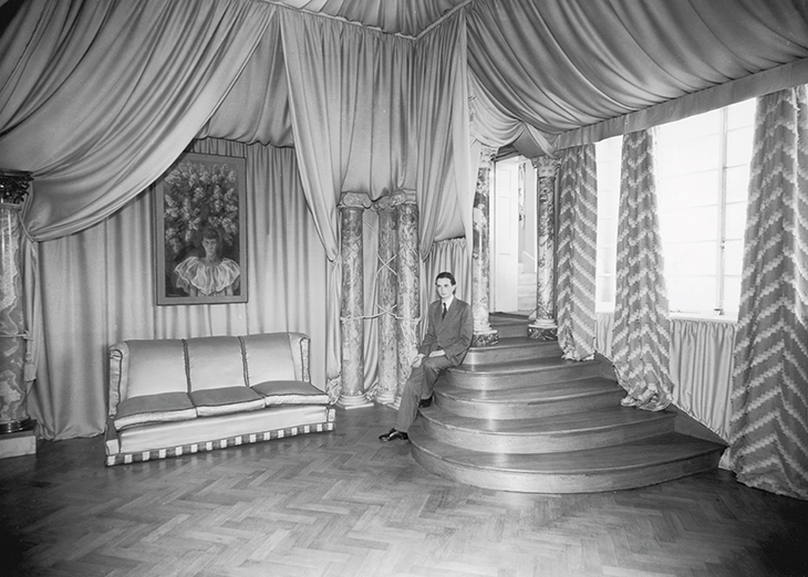 Edward James (1907–84) photographed in 1933 at his London home in Wimpole Street with a painting by Pavel Tchelitchew.