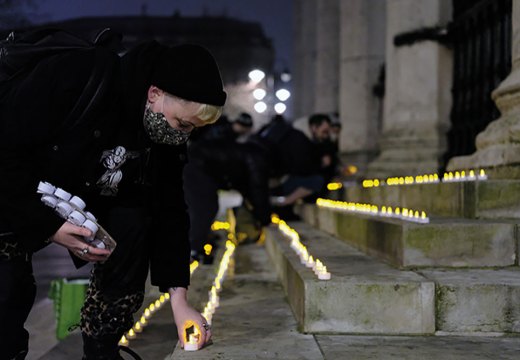 Carla Ecola, director of the Outside Project, lays memorial candles in Trafalgar Square as part of the Museum of Homelessness’s ‘Dying Homeless’ project (Photo: Anthony Luvera)