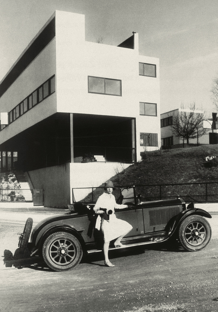 Woman posing by a car at the Weissenhof Estate in Stuttgart, 1927.