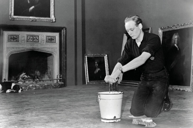 Edward, Lord Montagu of Beaulieu scrubbing floors in Palace House in 1952.