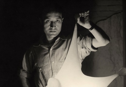 Isamu Noguchi with study for Luminous Plastic Sculpture, 1943