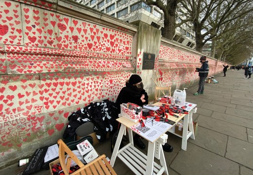 Clara Collingwood from Covid-19 Bereaved Families for Justice and Oliver Knowles of Led By Donkeys at the welcome desk of the Covid memorial wall on the Albert Embankment, London, in April 2021.