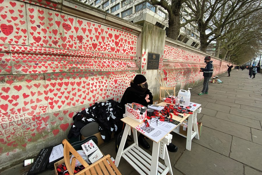 Clara Collingwood from Covid-19 Bereaved Families for Justice and Oliver Knowles of Led By Donkeys at the welcome desk of the Covid memorial wall on the Albert Embankment, London, in April 2021.