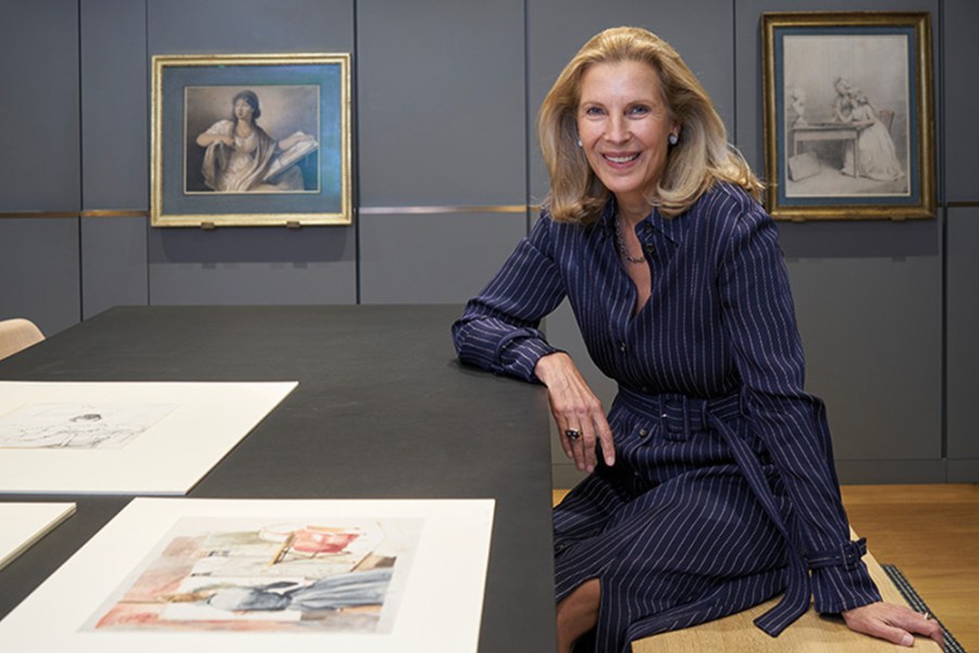 Katrin Bellinger photographed in her print room in London in May 2022. Behind her are drawings by Anne Guéret and Gjisbertus Johannus van den Berg.