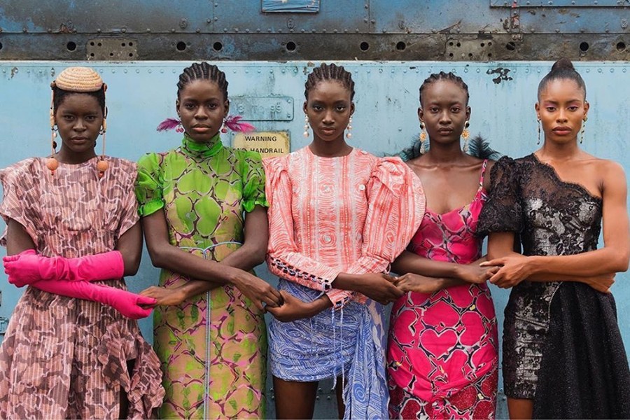 Models hold hands during Lagos Fashion Week. Courtesy Lagos Fashion Week; photo: Stephen Tayo