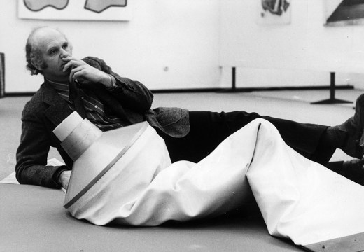 Pop artist Claes Oldenburg with one of his works, an outsize tube of toothpaste on display in the Dusseldorf Kunsthalle, West Germany.