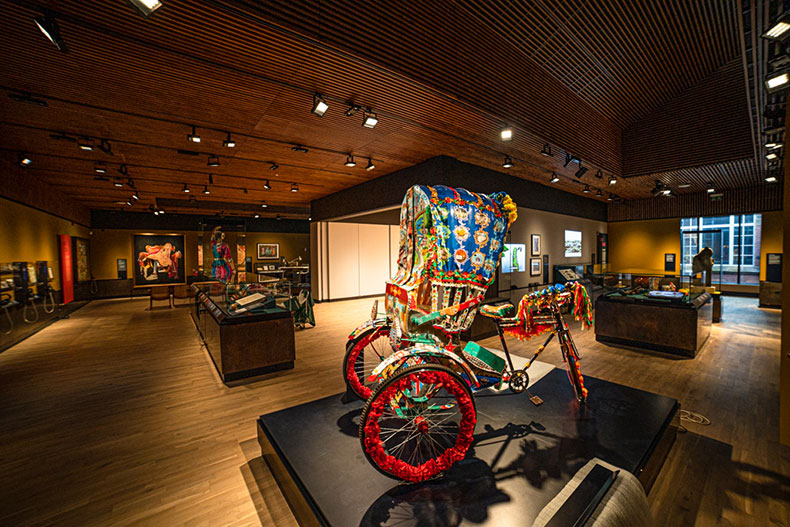 Museum display including colourfully decorated rickshaw