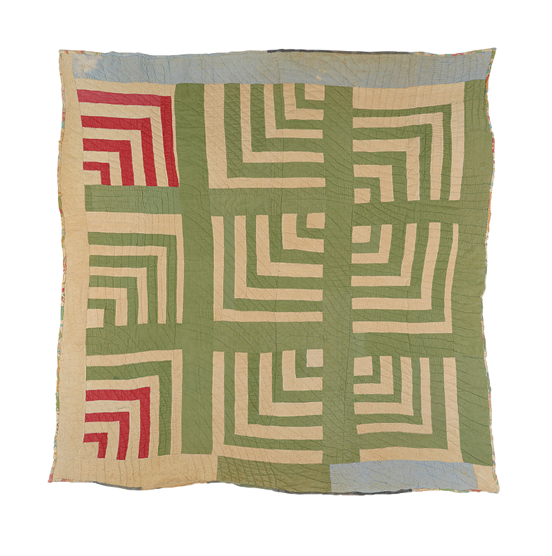 a quilt made of green and red textiles