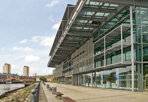 Facade of glass building on riverside