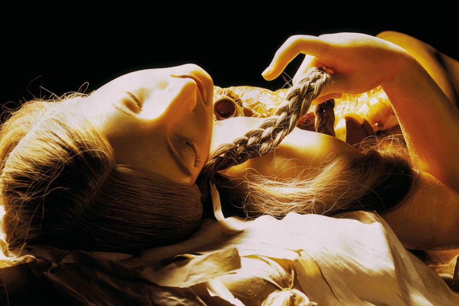 wax figurine of a girl lying down